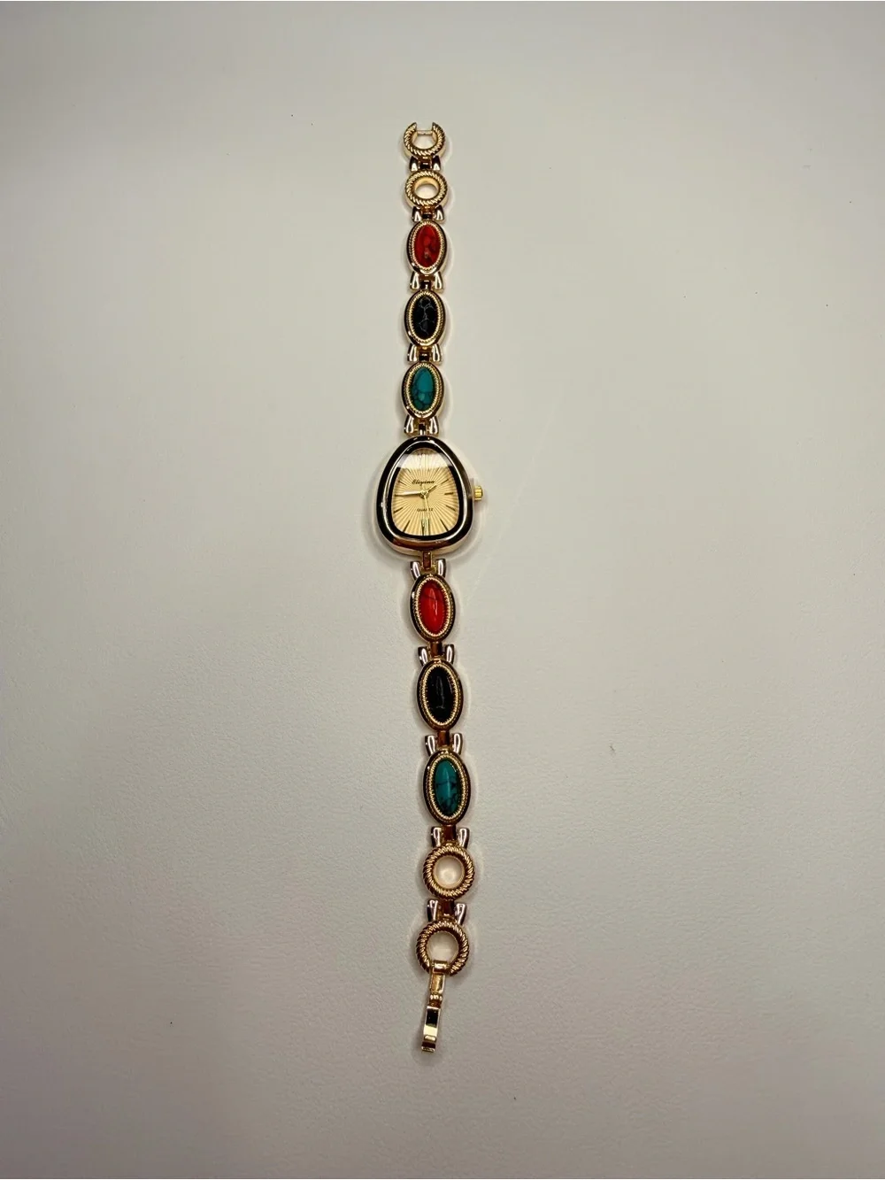 Gold Teardrop Dial Bracelet Watch with Red, Black and Turquoise Accents